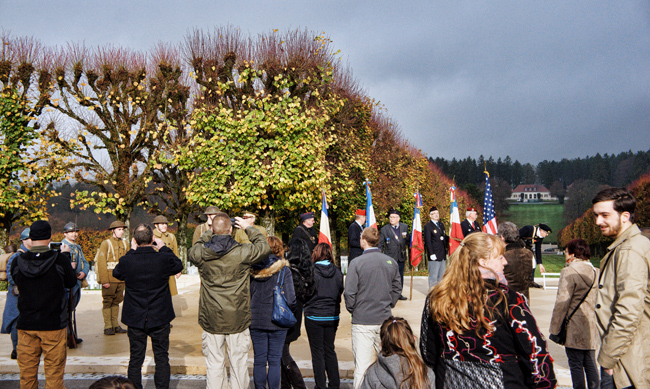 Photograph of small gathering of people on Veterans Day 2015 at the Meuse-Argonne American Cemetery.